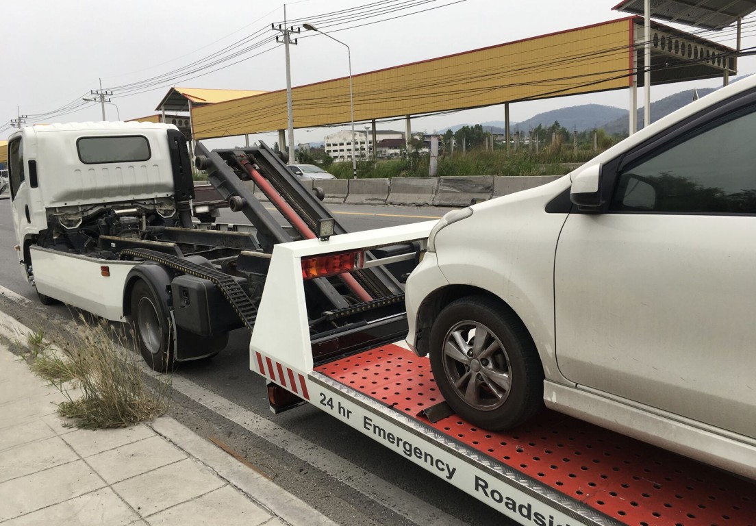24-hour emergency roadside assistance tow truck providing jump start service