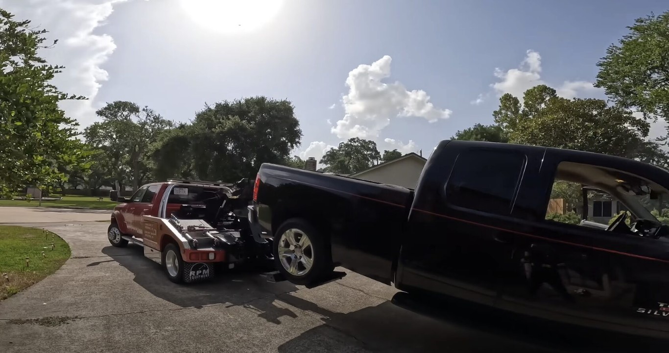 Accident recovery tow truck removing a vehicle from a residential street
