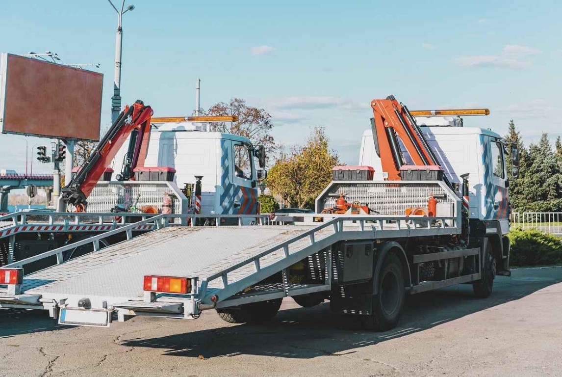 Flatbed tow trucks parked and ready for service